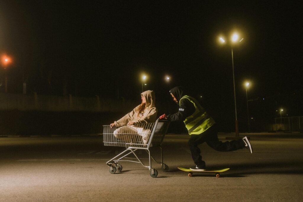 How To Stay Energized on Night Shifts: A Science-Backed Guide 1 Young adults skateboarding and playing with a shopping cart at night.