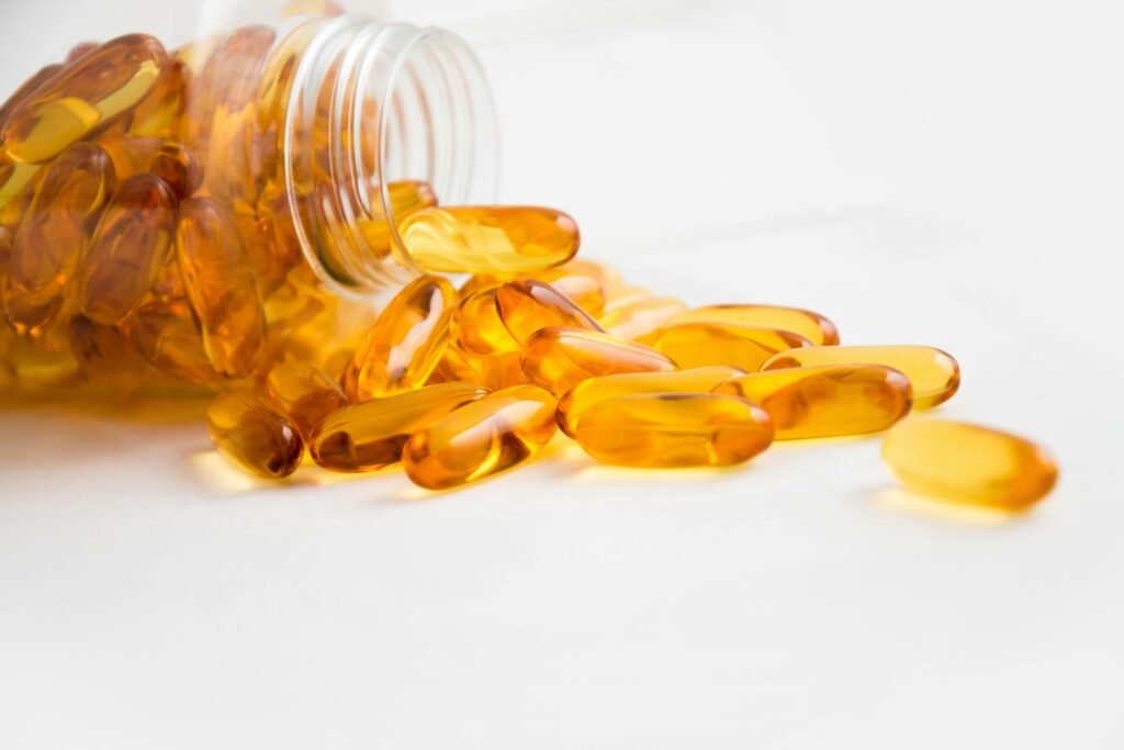 How to Fix Night Shift Sleep Problems: 7 Effective Solutions for Better Rest 5 Close-up of fish oil capsules spilling from a bottle on white background.
