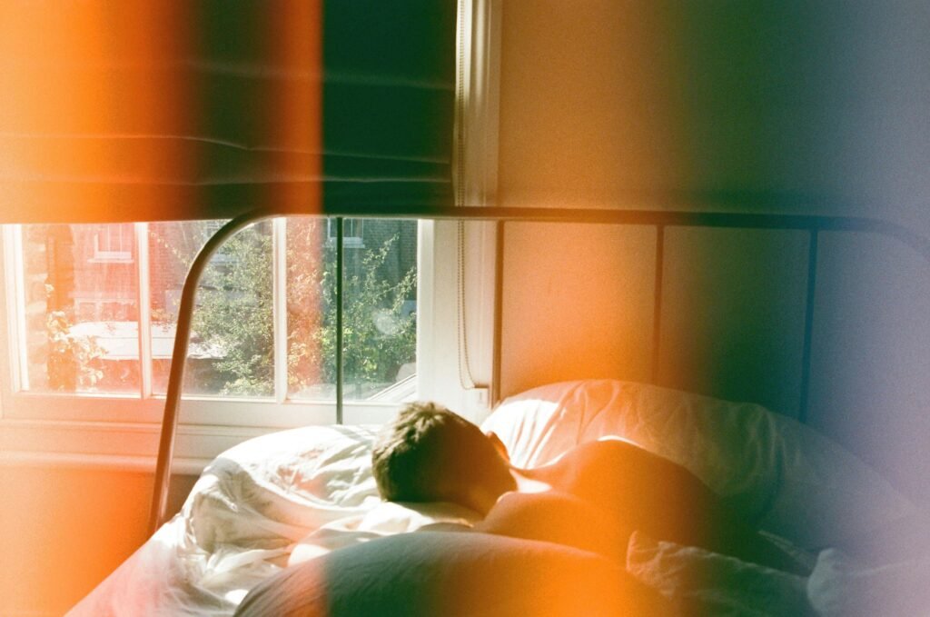 Stop Night Shift Weight Gain: 8 Proven Metabolism Boosters 7 A man peacefully sleeping in a London bedroom, bathed in soft morning light.