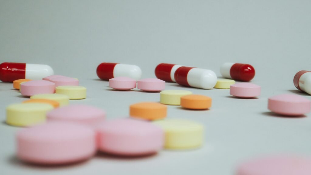 Stop Night Shift Weight Gain: 8 Proven Metabolism Boosters 9 Close-up of varied pills and capsules scattered on a white surface.