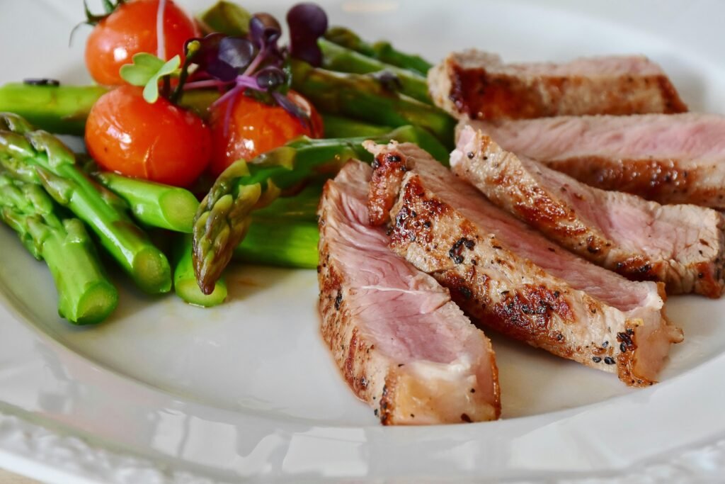 What to Do About Night Shift Memory Problems and Cognitive Decline 5 Close-up of grilled steak slices with asparagus and cherry tomatoes, perfect for a healthy meal.