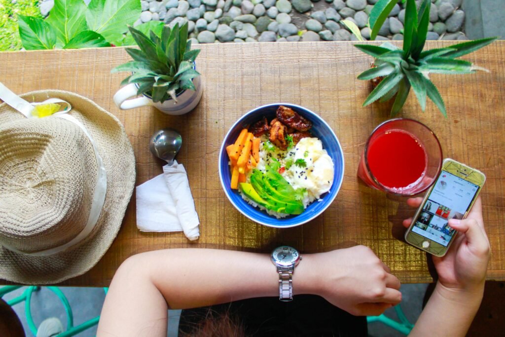 How to Combat Night Shift Skin Problems 4 Fresh and healthy bowl meal with juice and smartphone on a wooden table, perfect for lifestyle and food photography.