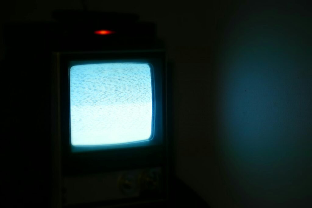 Essential Products for Night Shift Workers 3 A vintage television displaying static in a dimly lit room, evoking nostalgia and retro vibes.