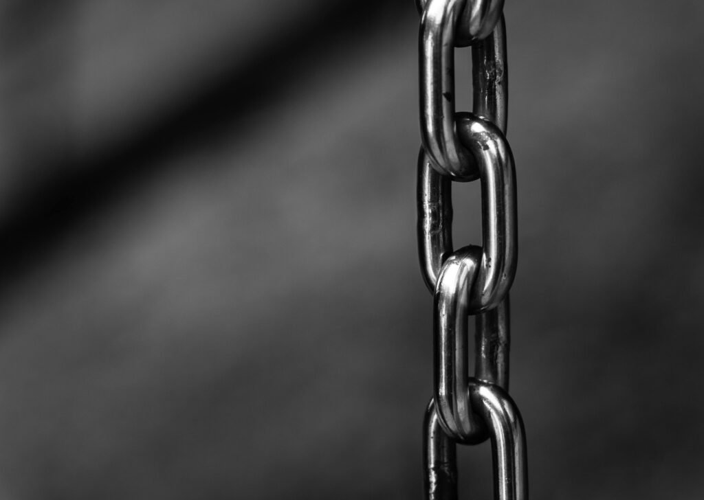 What to Do About Night Shift Depression: Recognition and Self-Care Steps 2 Detailed close-up of a strong shiny metallic chain link against a blurred background, emphasizing security.