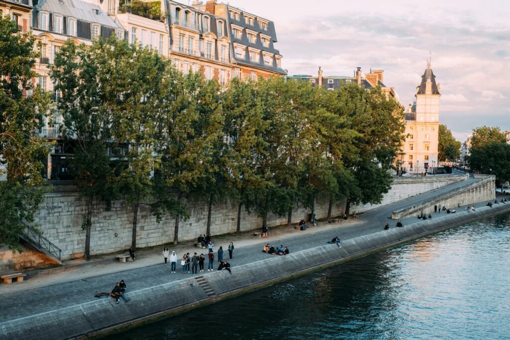 How to Stay Social and Connected in a Night Shift Lifestyle 4 Charming riverside promenade in Paris with historic architecture and people enjoying their day.