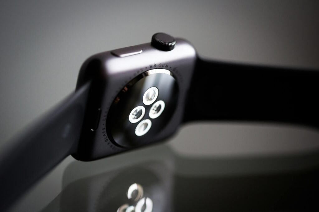 Essential Products for Night Shift Workers 7 Detailed image of the back sensor of a modern smartwatch showing reflective surface and technology focus.