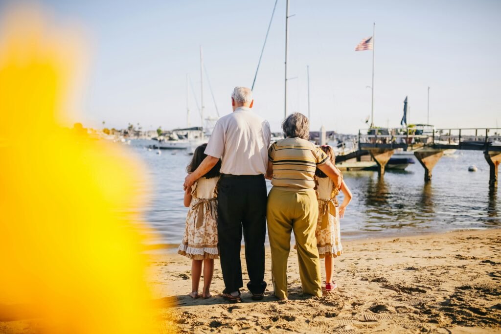 How to Stay Social and Connected in a Night Shift Lifestyle 5 A multigenerational family enjoys a sunny day by the seaside, capturing togetherness and joy.