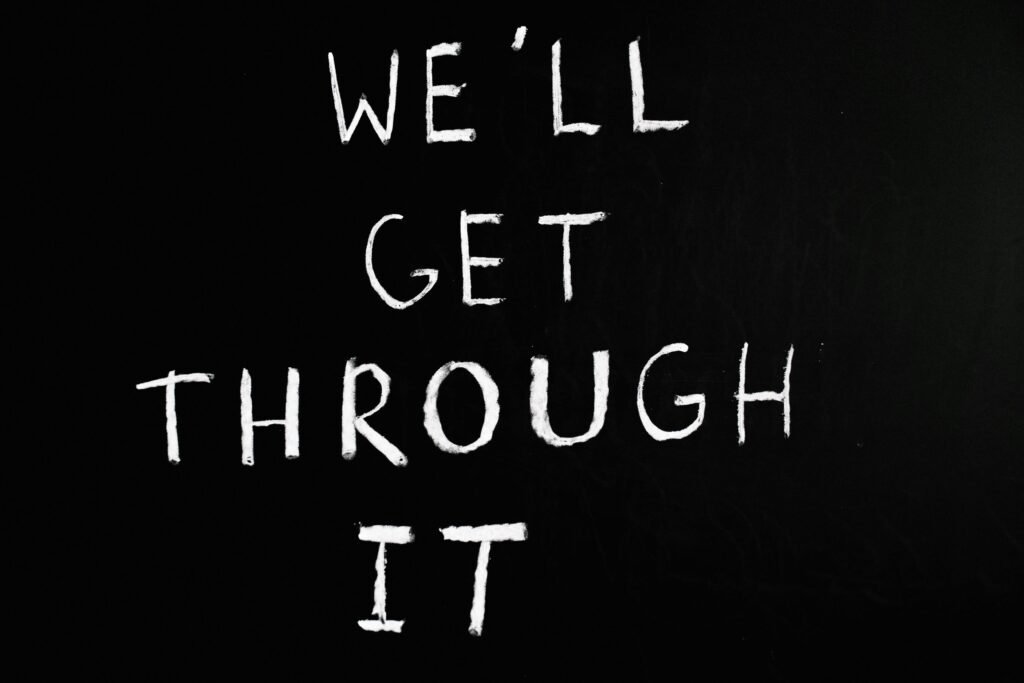 What to Do About Night Shift Depression: Recognition and Self-Care Steps 11 A motivational chalkboard message reading 'We'll get through it' on a black background.