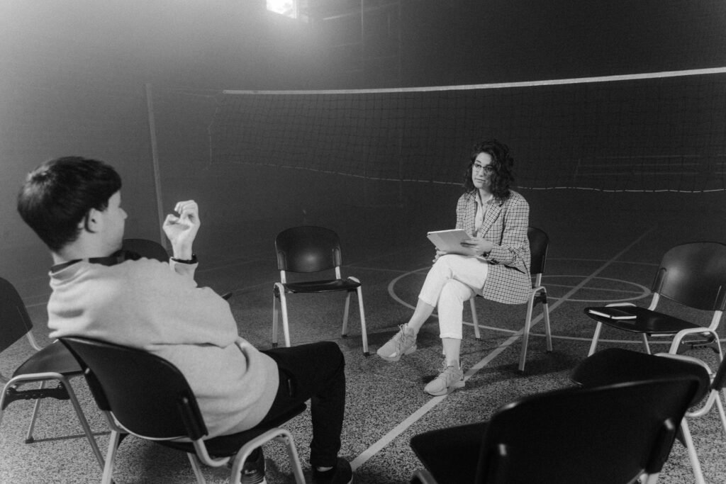 What to Do About Night Shift Depression: Recognition and Self-Care Steps 10 A black and white image capturing a one-on-one counseling session in an indoor setting.