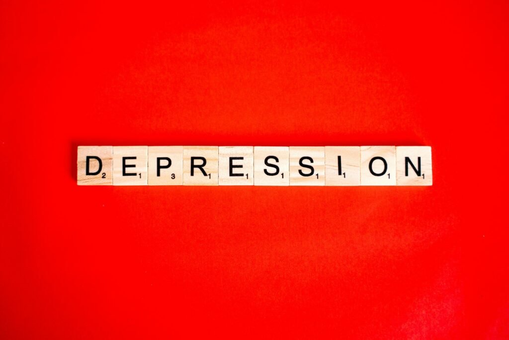 What to Do About Night Shift Depression: Recognition and Self-Care Steps 1 Word depression spelled with letter tiles on vibrant red background, highlighting mental health theme.