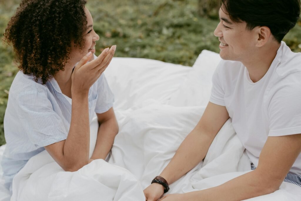 Night Shift and Relationships: Communication Solutions That Work 3 A happy couple smiling and chatting outdoors in a relaxed, romantic setting.