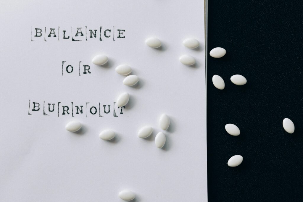 How to Build Immunity Against Frequent Night Shift Illnesses 6 Conceptual image featuring 'Balance or Burnout' text with scattered white capsules.