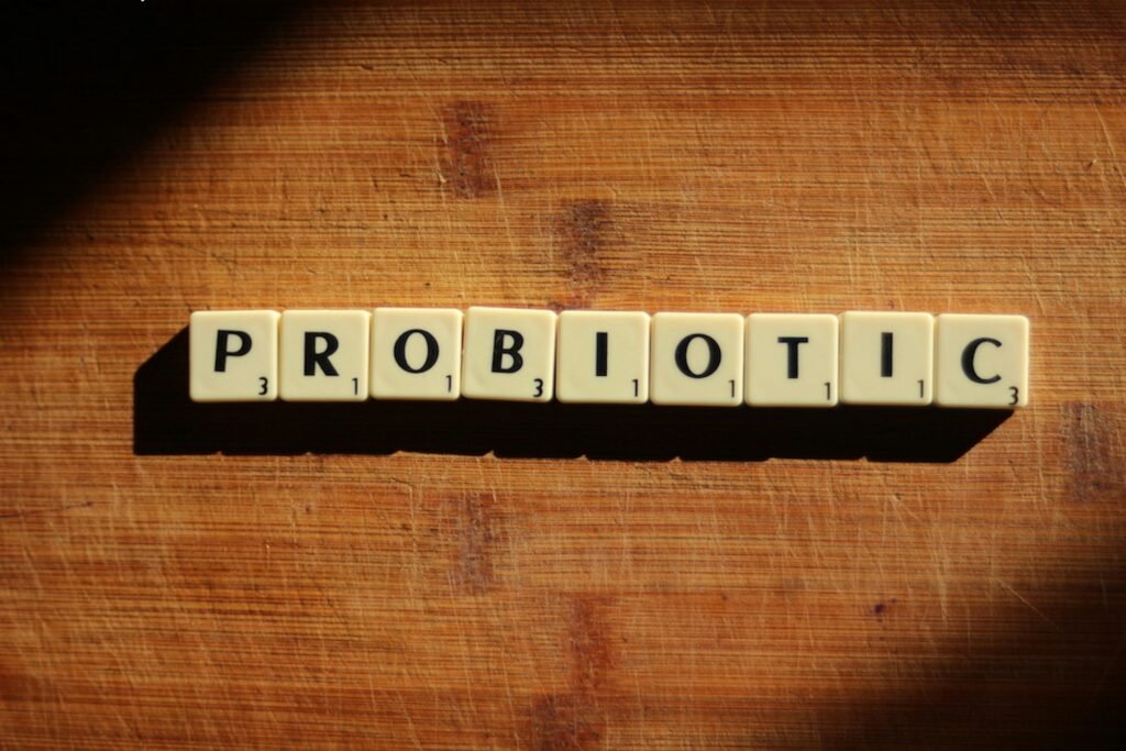 How to Manage Night Shift Digestive Problems 8 Close-up of the word 'probiotic' crafted from letter tiles on a wooden surface.