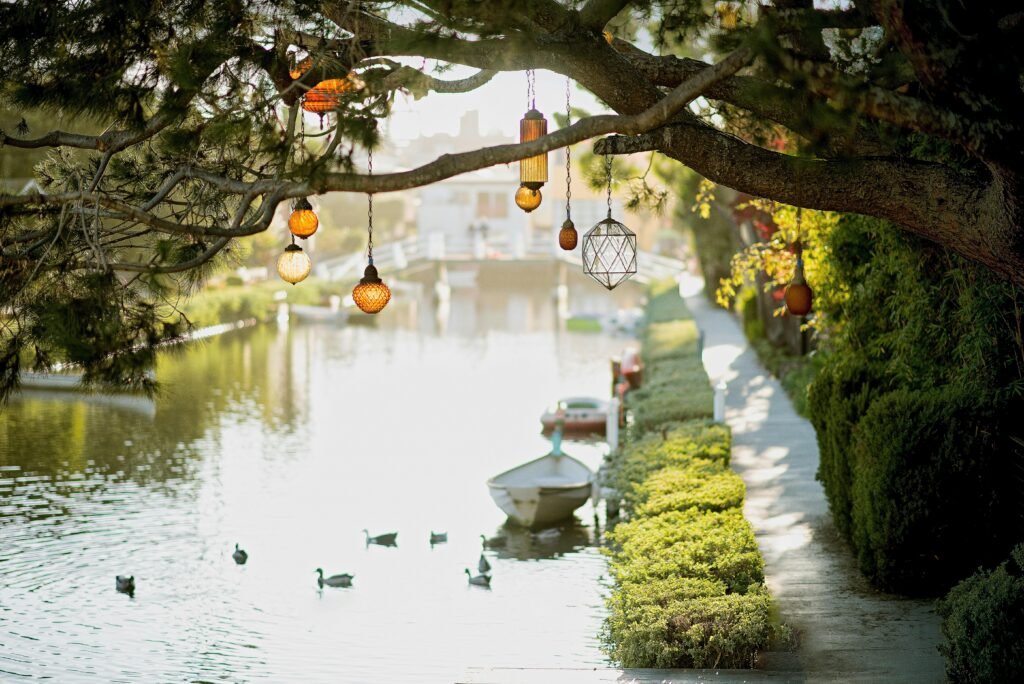 How to Combat Night Shift Skin Problems 6 Peaceful waterway with ducks and decorative lanterns on a tree branch.