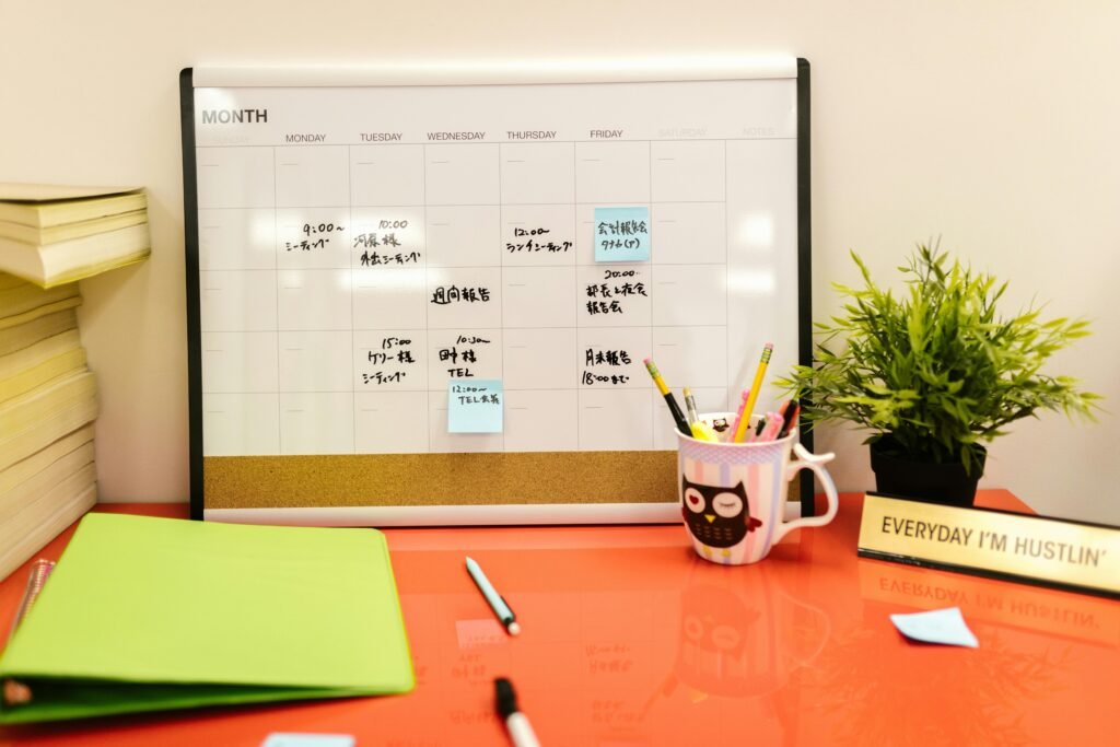 Night Shift and Relationships: Communication Solutions That Work 2 Neat workspace with a calendar, plant, and stationery on a red desk.