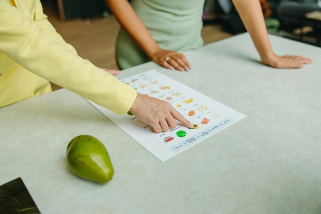 How to Manage Night Shift Digestive Problems 11 Two adults discussing food options with a chart, highlighting healthy nutrition indoors.