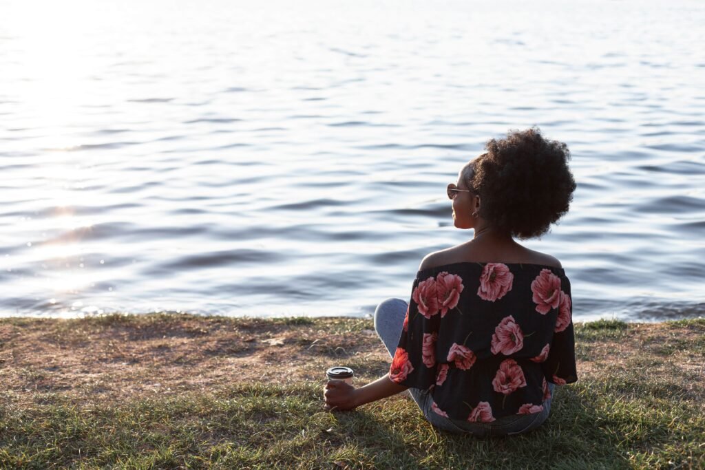 The Night Shift Advantage: Surprising Benefits No One Talks About 5 back view beautiful african woman sitting ground 1