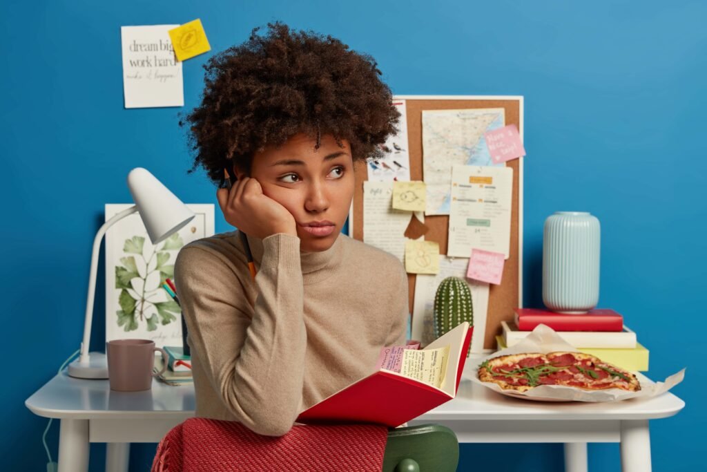 sad thoughtful university student holds notebook with sticky colorful notes inside 1