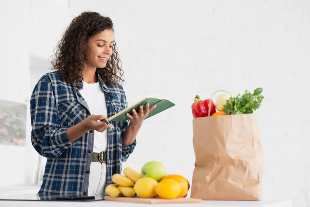 woman holding notebook vegetables bag 1