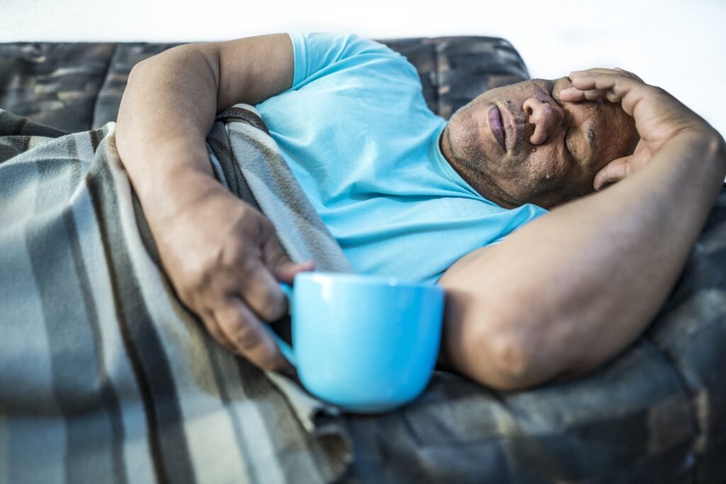 picture male laying sofa with blue cup 2 1